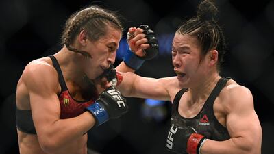 Weili Zhang lands a punch on Joanna Jedrzejczyk during their fight at UFC 248. AFP