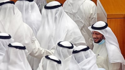 Kuwaiti Finance Minister Barak Al Sheetan greets colleagues during a parliament session at Kuwait's national assembly in Kuwait City. AFP