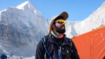 Left, platoon commander Sheikh Theyab Al Nahyan on Everest; team members navigate their way across a crevasse.