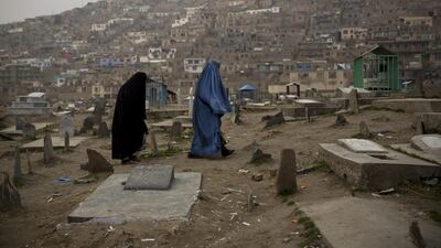 Afghan women cross a cemetery in the centre of Kabul, Afghanistan. (Anja Niedringhaus / AP Photo / March 7, 2014)