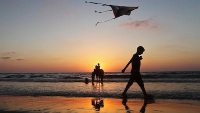 A Palestinian child flies a kite at Shaik Ajlen beach in the Gaza Strip, on 06 July 2012. ALI ALI/EPA