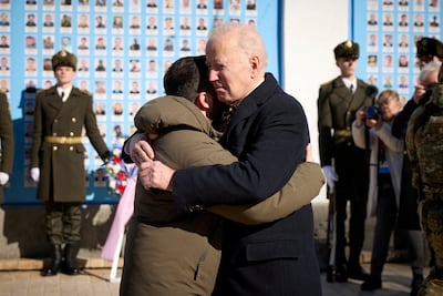 US President Joe Biden embraces Ukraine's President Volodymyr Zelenskiy as they visit the Wall of Remembrance to pay tribute to fallen Ukrainian soldiers, in Kyiv, February 20, 2023. Reuters