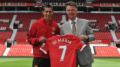 Angel di Maria poses with Manchester United manager Louis van Gaal shortly after signing with the club from Real Madrid in August. Steve Parkin / AFP / August 28, 2014