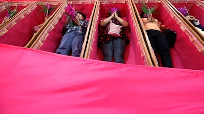 Worshippers pray as they take turns lying in coffins at the Takien temple in suburban Bangkok, Thailand. Worshippers believe that the coffin ceremony – symbolising death and rebirth – helps them rid themselves of bad luck and are born again for a fresh start in the new year. AP Photo