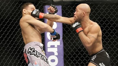 Demetrious Johnson lands a shot to the face of John Dodson during their flyweight title bout. Pic: Nam Y Huh/AP