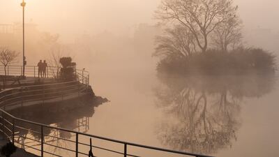 Nepalese people jog around Taudaha Lake on the outskirts of Kathmandu, Nepal, on a cold and foggy morning. AP