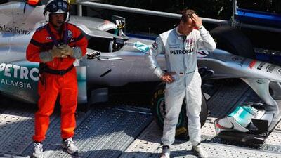 Michael Schumacher stands beside his Mercedes GP car after crashing out at St Devote during practice for the Monaco GP.