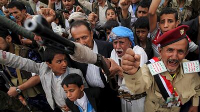 A follower of the Houthi movement raises his rifle as he shouts slogans during a rally against the Saudi-led coalition in Yemen's capital Sanaa last month. Mohamed Al Sayaghi / Reuters