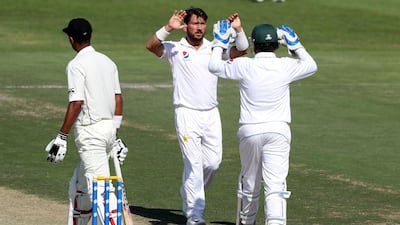 Pakistan's Yasir Shah celebrates the wicket of New Zealand's Jeet Raval during the opening day of the third Test match in Abu Dhabi. Chris Whiteoak / The National