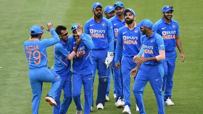 India's Ravindra Jadeja celebrates with teammates after running out New Zealand's James Neesham. AP