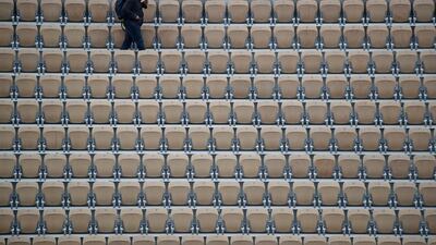 A spectator with an umbrella walks away after all matches of the French Open tennis tournament were cancelled due to rain at the Roland Garros stadium in Paris. AP