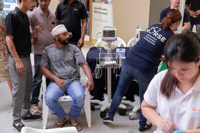 This health awareness activity is part of a social responsibility and welfare campaign that is focused on motivating blue collar workers to adopt healthy habits. A labourer has his blood pressure tested. Antonie Robertson / The National