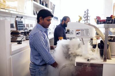 Azad Sonu prepares an ice cream with the owner Zunin Doshi at Scoopi Cafe. Anna Nielsen / The National