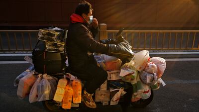 A delivery rider in Beijing. China has eased coronavirus restrictions across the country. AP