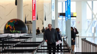 A passenger walks to a nearly empty security checkpoint at LaGuardia Airport in New York. Reuters