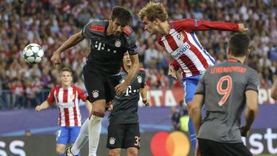 Atletico Madrid’s Antoine Griezmann, right, fights for the ball with Bayern Munich’s Javi Martinez. Juanjo Martin / EPA