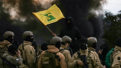 A Hezbollah supporter waves the group's flag in front of Lebanese army troops. AFP