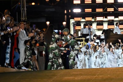 Louis Vuitton men's creative director Pharrell Williams embraces his family, wife Helen Lasichanh and children, after the show as part of Paris Fashion Week. Getty Images