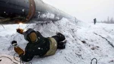 A worker welds a pipeline at the South-Russian OAO Gazprom gas field, 250 km from Urengoy, Eastern Siberia, Russia.