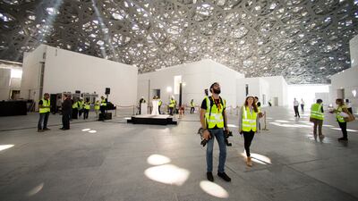 Workers inside Louvre Abu Dhabi, beneath the Rain of Light dome, in 2017. Christopher Pike / The National