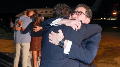 Coming off the plane, the returning Americans were embraced by family and friends with smiles, laughs, and visible emotion. AP