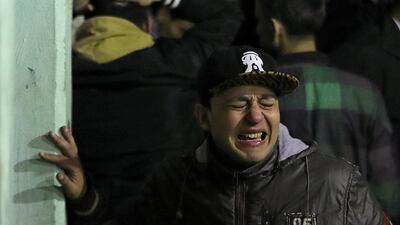 People react at the scene of an explosion in central Cairo where two policemen and the bomber were killed. Reuters