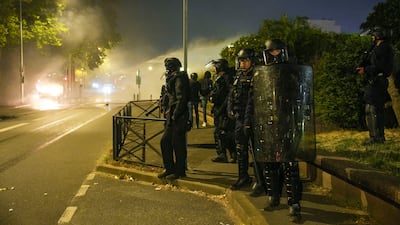Police officers patrol in Nanterre, outside Paris. AP
