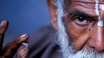 A Hindu holy man applies tika on his forehead at the premises of Pashupatinath Temple a day ahead of the Shivaratri festival in Kathmandu, Nepal. Reuters