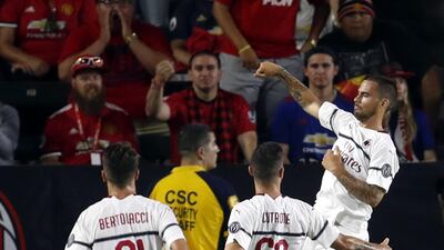 AC Milan's Suso celebrates with teammates after scoring a goal. EPA