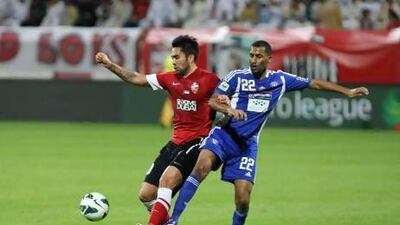 Luis Jimenez, left, shields the ball from an Al Nasr player during last night's 2-2 draw. Jaime Puebla / The National Newspaper