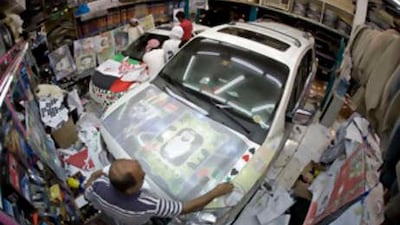 A car is decorated in a shop on Al Salam Street for the car parade on the Corniche during the 37th National Day in Abu Dhabi, on Dec 1 2008.