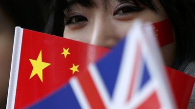 A supporter of China's President Xi Jinping waits on the Mall for him to pass during his ceremonial welcome, in London (REUTERS/Peter Nicholls)