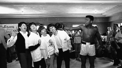 In this February 18, 1964 file photo, Cassius Clay poses with The Beatles, from left, Paul McCartney, John Lennon, Ringo Starr and George Harrison, while visiting the heavyweight boxing contender at his training camp in Miami Beach, Fla. Fifty years ago, these future legends met through a chance of publicity matchmaking. AP Photo