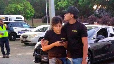 A young couple embrace at the festival's car park. AP