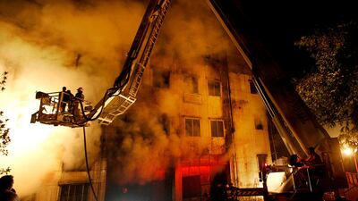 Bangladeshi firefighters battle a fire at a garment factory in the Savar neighborhood in Dhaka, Bangladesh. AP Photo / Hasan Raza