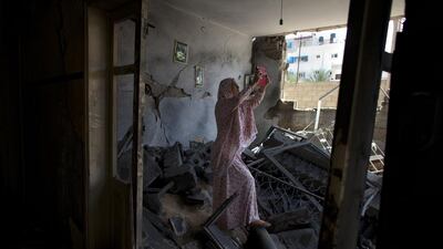 Palestinian Hadil Amar, 21, uses her tablet to photograph herself with the damage to her family’s home in Tel Al Hawa in central Gaza. The family fled their home just before a ceasefire after it was hit with a warning rocket by an Israeli drone. Witnesses claim the home was hit twice.