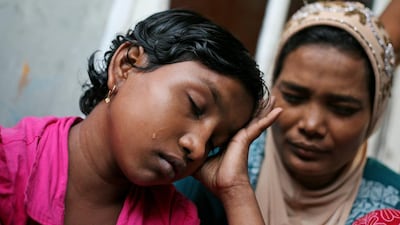 Senwara Begum cries at a temporary shelter in Medan, North Sumatra, Indonesia after making a phone call to her family in Myanmar. AP Photo/Binsar Bakkara