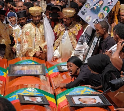 A woman lies on the coffin of her loved one during a memorial service for the Ethiopian passengers and crew who perished in the Ethiopian Airways ET302 crash at Selassie Church on March 17, 2019 in Addis Ababa, Ethiopia. Getty Images