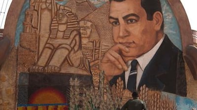 An Egyptian soldier walks up the steps next to a stone mural with an image depicting former Egyptian president Hosni Mubarak on the outskirts of Cairo.
