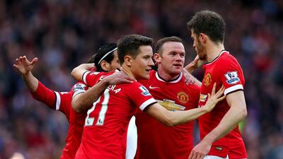 Manchester United players celebrate with Wayne Rooney after he scored the second in the 3-1 victory over Aston Villa. Alex Livesey / Getty