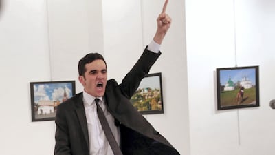 Police officer Mevlut Mert Altintas, shouts after shooting Andrei Karlov, the Russian ambassador to Turkey, in Ankara in 2016. Altintas was killed by police shortly afterwards. AP