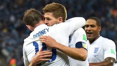 Steven Gerrard embraces Wayne Rooney after his goal on Thursday against Uruguay, as Glen Johnson looks on, at the 2014 World Cup in Sao Paulo, Brazil. Ben Stansall / AFP