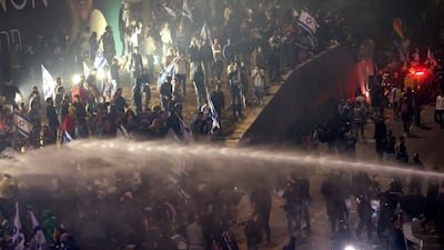 Police use a water cannon on violent protesters in Tel Aviv. AFP