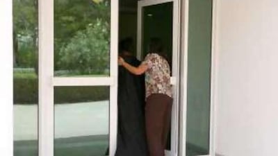 A caseworker escorts a woman inside the Dubai Foundation for Women and Children recently.