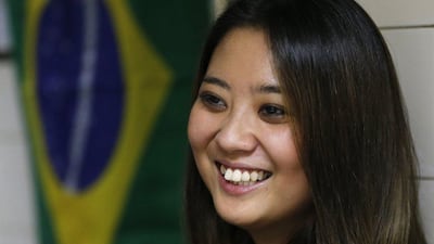 In this June 10, 2014, photo, Sao Paulo’s former Miss Okinawa, Lais Miwa Higa, speaks during an interview at Bar Kintaro in Sao Paulo, Brazil. The elite Sao Paulo University Master’s degree student in anthropology, who is considering a PhD, has trouble being perceived among Brazilian peers as more than a Japanese geisha doll. Shuji Kajiyama / AP