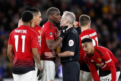 Manchester United's Paul Pogba speaks with referee Martin Atkinson during the match. Reuters