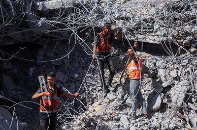 Gaza civil defence personnel search under rubble in Gaza city. Their work is hampered by a lack of equipment. Reuters