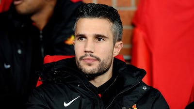 Robin van Persie watches a match from the bench with Manchester United in December 2013. Andrew Yates / AFP / December 10, 2013