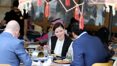 Men and women eat food at a restuarant in Riyadh, Saudi Arabia. Reuters