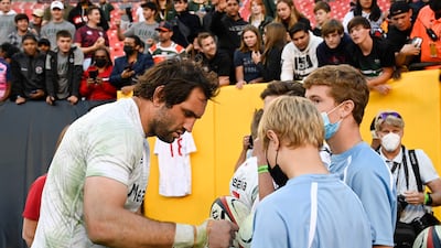 Samuel Whitelock of the All Blacks signs autographs after the match. AFP